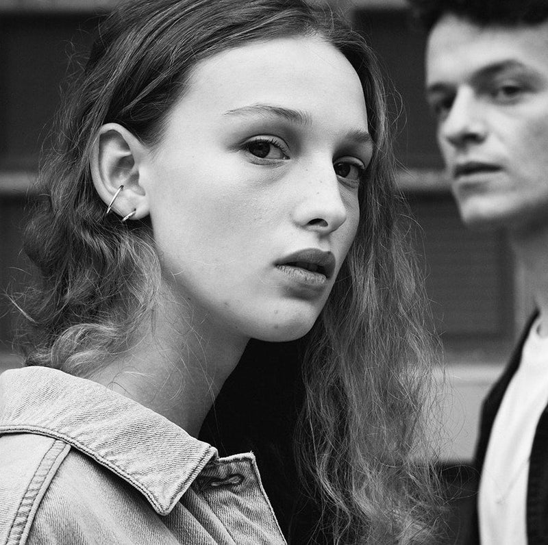 Black and white photo of a model who is wearing the Gloria earrings, designed by Aurore Havenne.